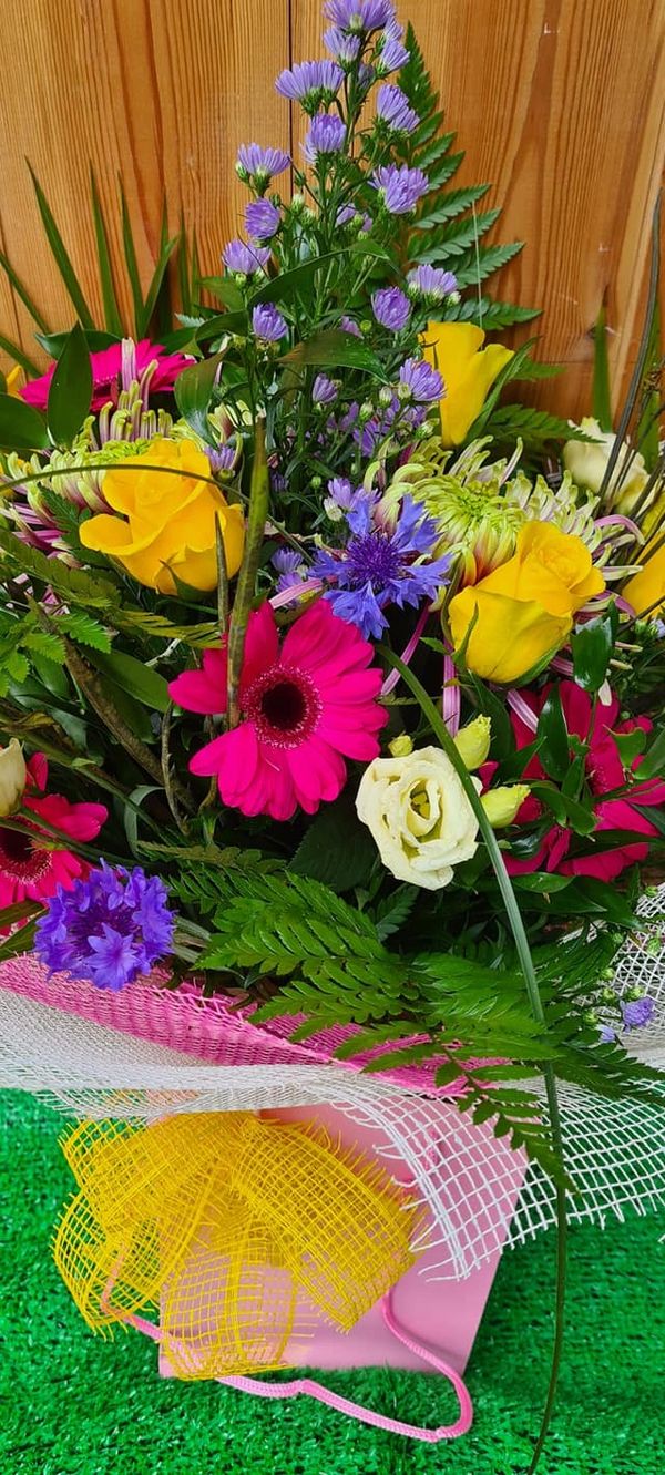 Bright and beautiful delicate cornflowers with hot pink gerbra and yellow roses 