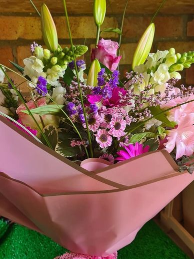 Pale pastel bouquet, white lilly white antirrhinum shocking pink germini statice wraped in rose pink