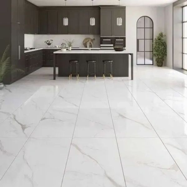 Modern kitchen with dark cabinets and marble floor tiles.