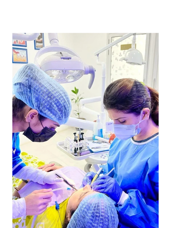 Dental professionals performing a procedure on a patient in a clinic.