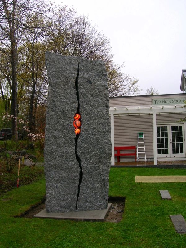 Large granite sculpture with what looks like lava bubbling out of the rock