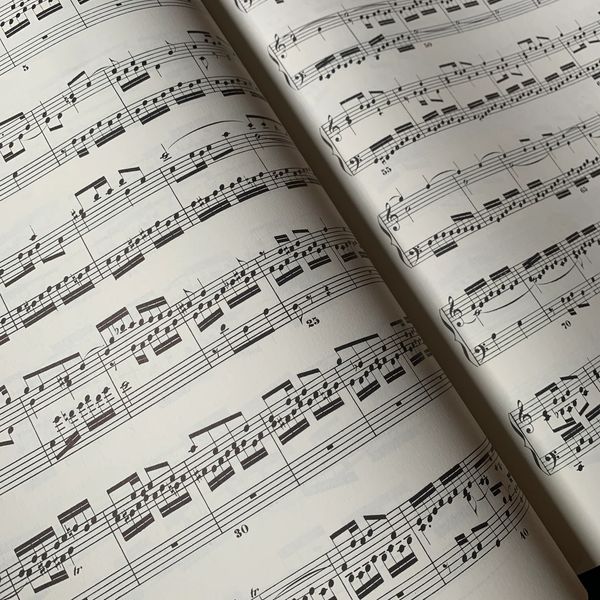 Open sheet music with musical notes on staff lines.