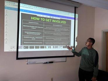Person giving presentation on how to get involved in research opportunities.