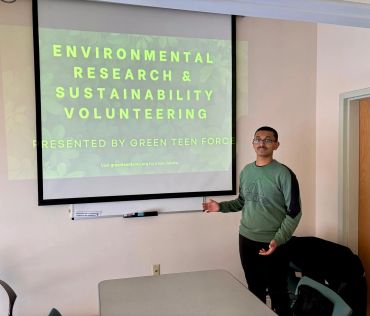 Person presenting on environmental research and sustainability volunteering.