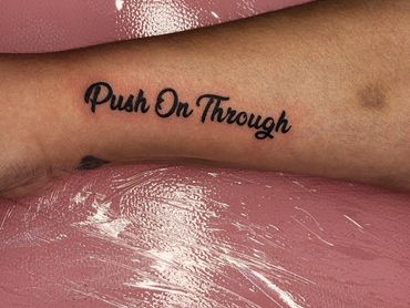 Tattoo with the phrase 'Push On Through'.