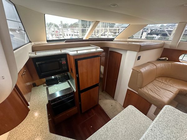 Cozy yacht kitchen and seating area with wood finishes and large windows. Your welcome to put your f