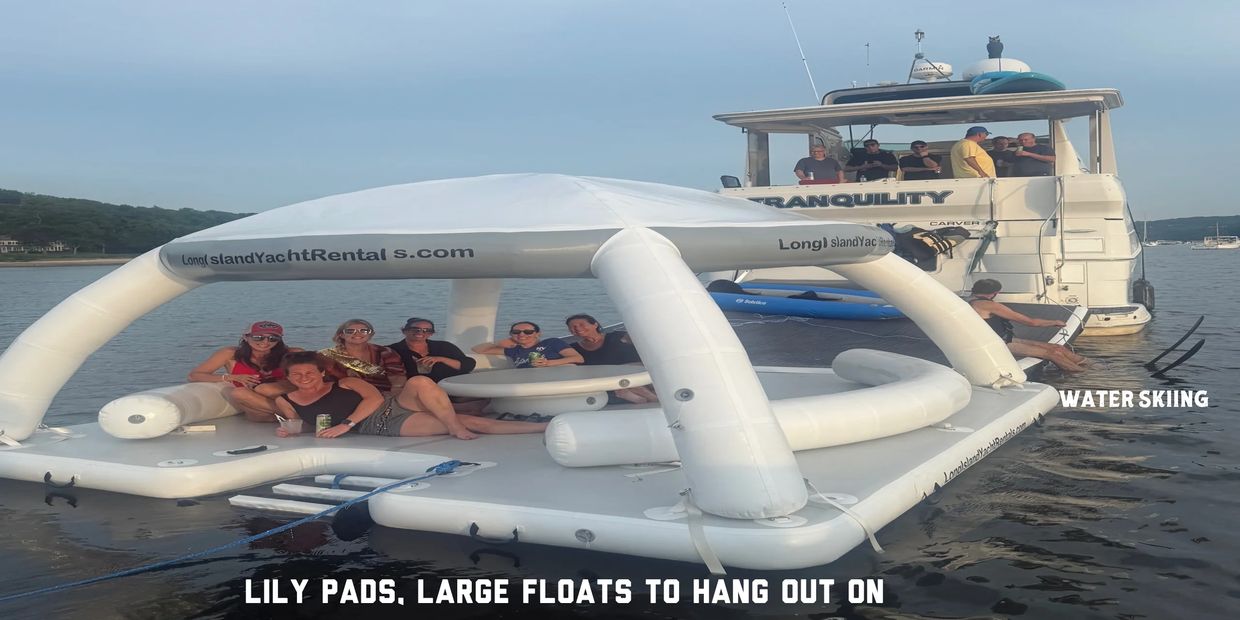 Group of people enjoying on an inflatable raft and yacht named Tranquility.