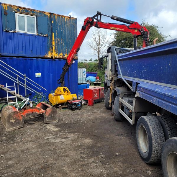 Lorry and crane outside workshop for hydraulic repairs.