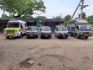 Five ambulances of Abrahmaan Imdad Welfare Society parked in a row.