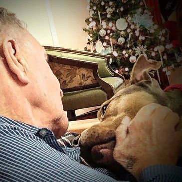Assisted living resident with one of our dogs during a therapy dog session