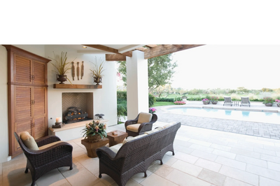 A lovely outdoor living space with a clean patio and render.