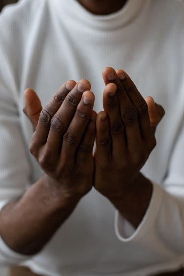 A man showing pray gesture