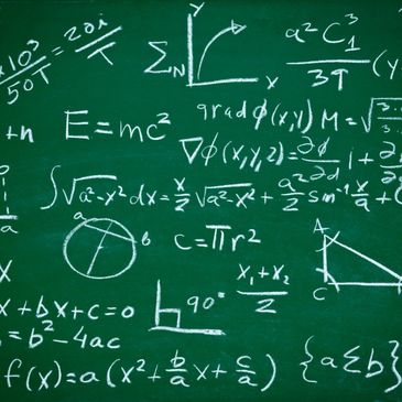 Mathematical formulas in chalk on a green chalkboard