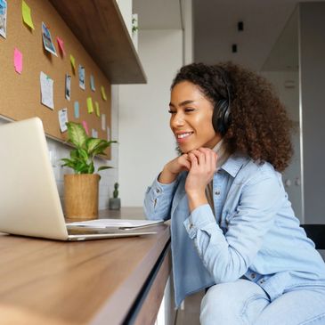 Student smiling as she participates in an online college interview via video chat