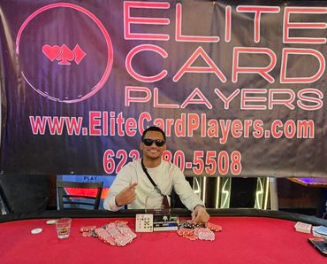 Man celebrating poker win with chips, cards, and trophy at Elite Card Players event.