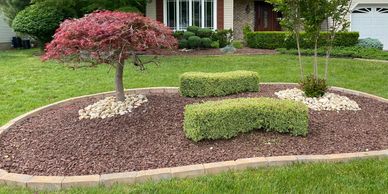 Freshly trimmed bushes and red stone installed in morganville nj