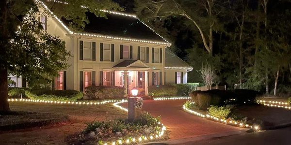 Large two story house with driveway lights. Christmas outdoor lights.