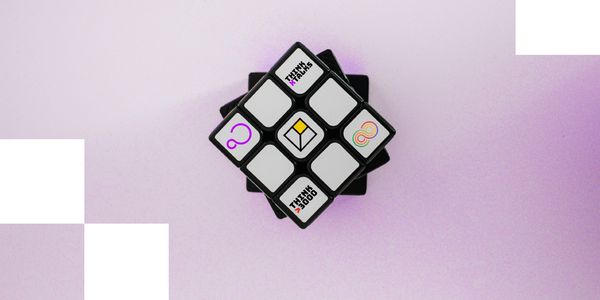 Rubik’s cube on a lavender background featuring Just Gold's flagship initiatives on white tiles.