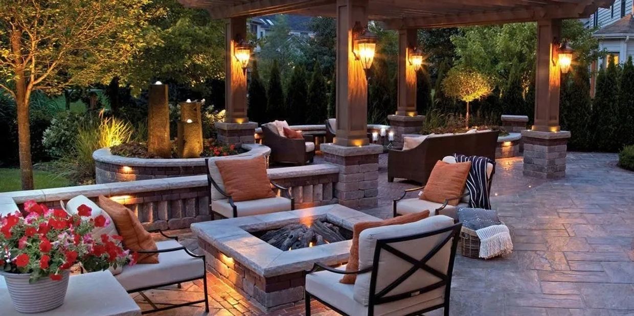 A beautiful, modern patio with built in fireplace and pergola.