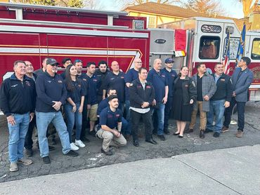 Men and women in suits mingling at a professional mixer