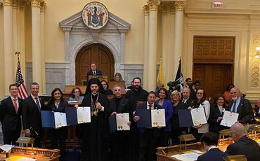 Team of executives posing for a group photo at a business gala