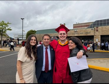 Businessmen and businesswomen gathered around a presentation at a trade show