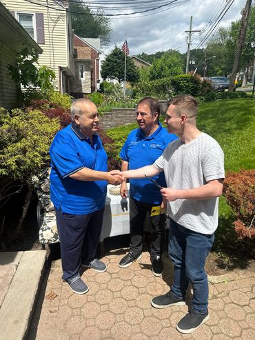 Three executives standing together, smiling at a corporate networking event