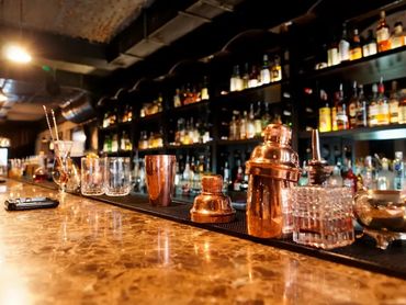 Traditional Liverpool pub interior with wooden bar counter and professional setting.