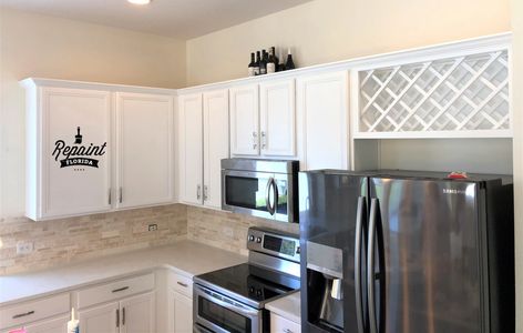 after pic of kitchen cabinet painted white by Repaint Florida in lake nona area of orlando fl 32827