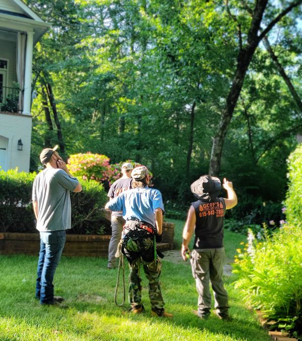 Josh Goff meeting with clients to discuss tree work to be done after their free estimate.