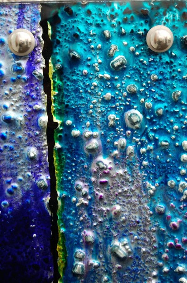 closeup of blue green and yellow colors on glass