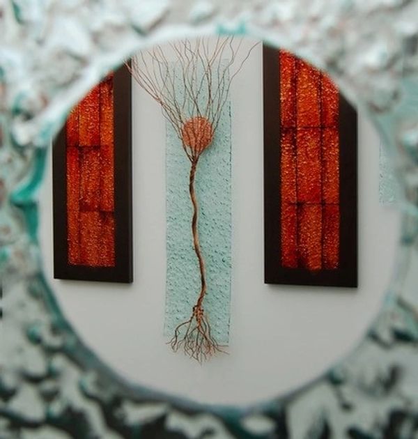 looking at three glass artworks through a hole