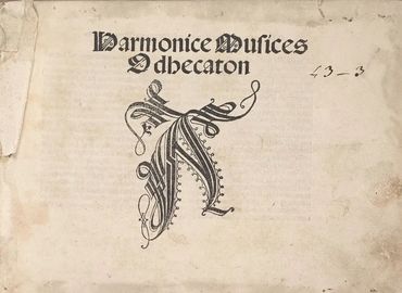 Old manuscript titled Harmonice Musices Odhecaton with ornate lettering.