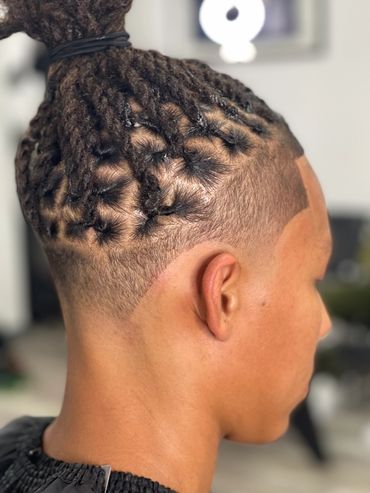 Close-up of a fresh dreadlock hairstyle with a clean fade.