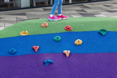 Feet walking on softfall rubber surface