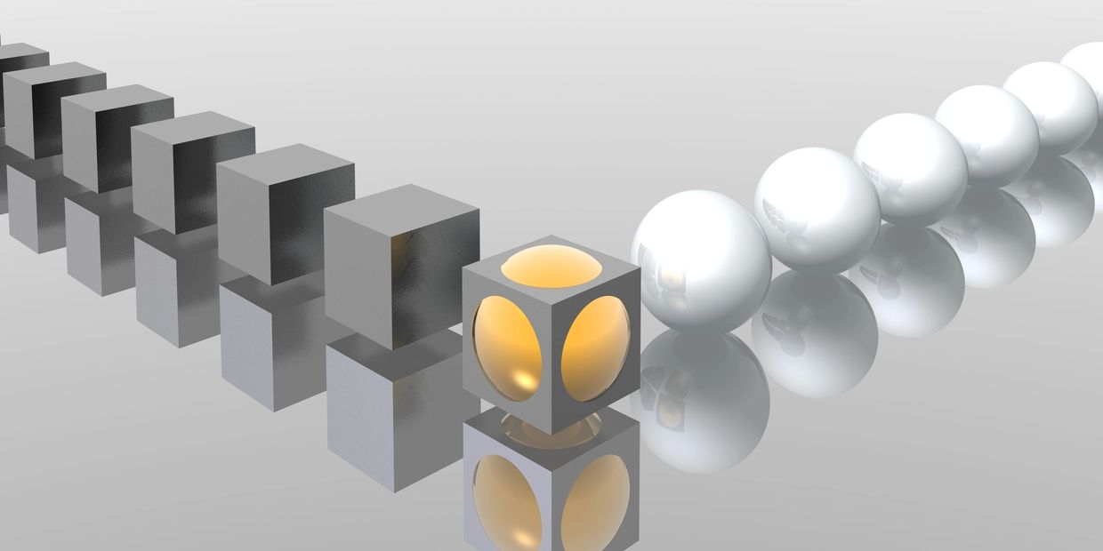 Line of gray cubes and white spheres with a glowing cube in the center.