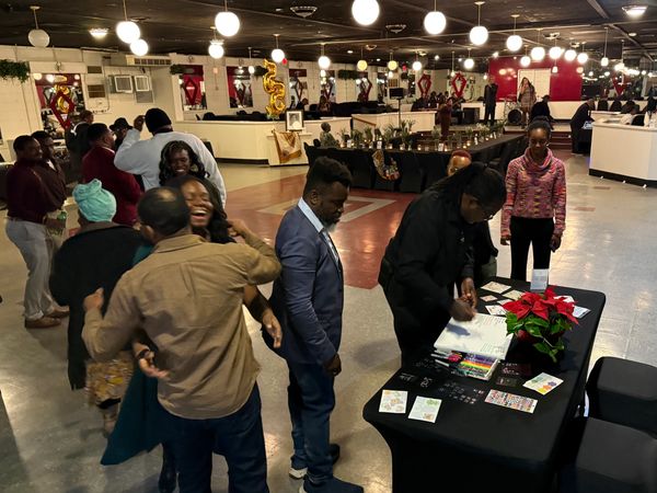 Group of people greeting and signing a gift