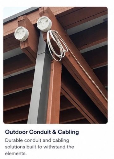 Outdoor conduit and cabling with exposed wiring on wooden beams.