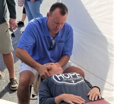 Dr Bailey adjusting a regular patient at the Lavonia Fall Festival 2021