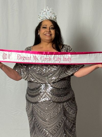 Woman wearing a crown and holding an Elegant Ms. Circle City Indy sash.