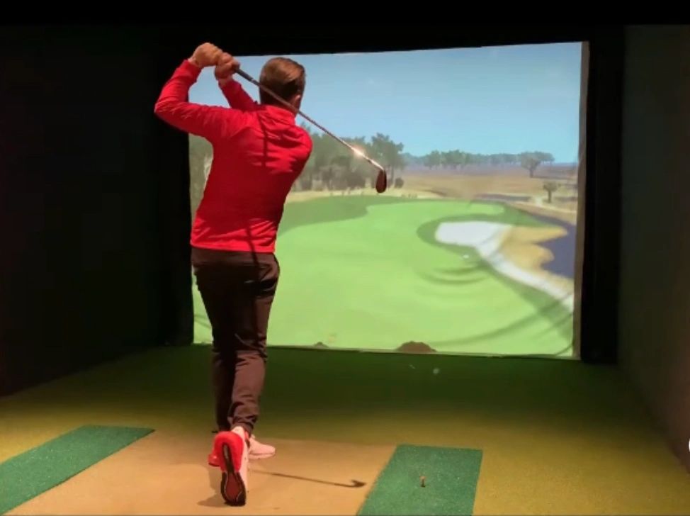 Lead PGA Pro, Steve Smith hits his approach shot in one of London Golf School's golf simulators