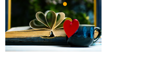 Intriguing image of an old, open tattered book with pages looped into a heart-like shape. Luv books.