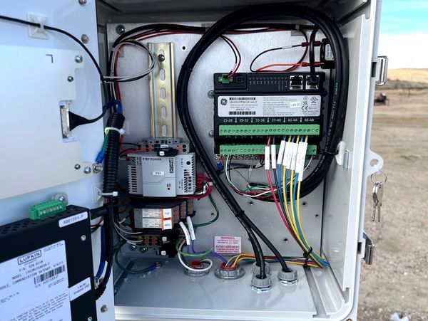 Open electrical control panel with wiring and labeled connections.