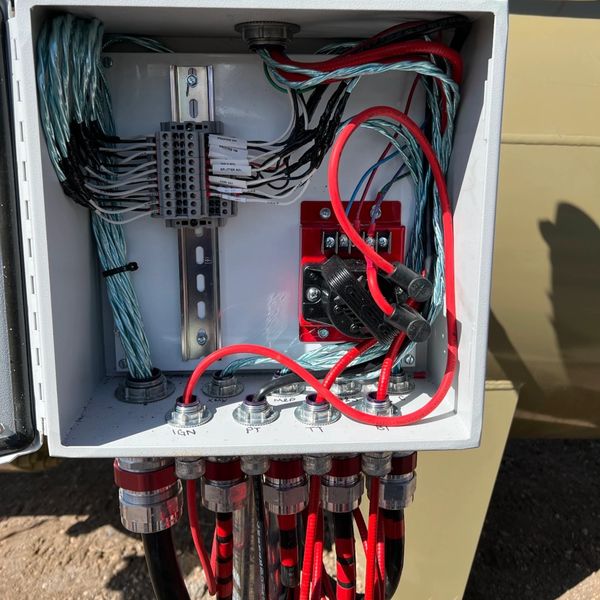 Electrical junction box with organized wiring and labeled connectors.