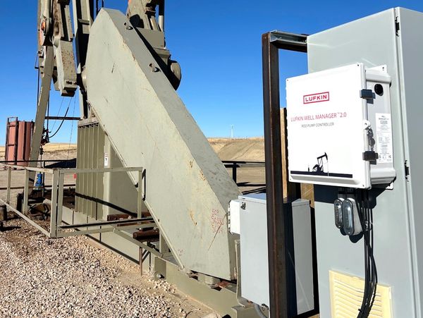 Lufkin well manager device attached to oil pumpjack machinery outdoors.