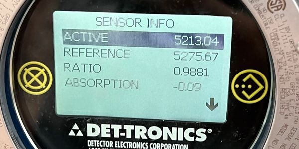 Close-up of a DET-TRONICS sensor display showing sensor info and readings.
