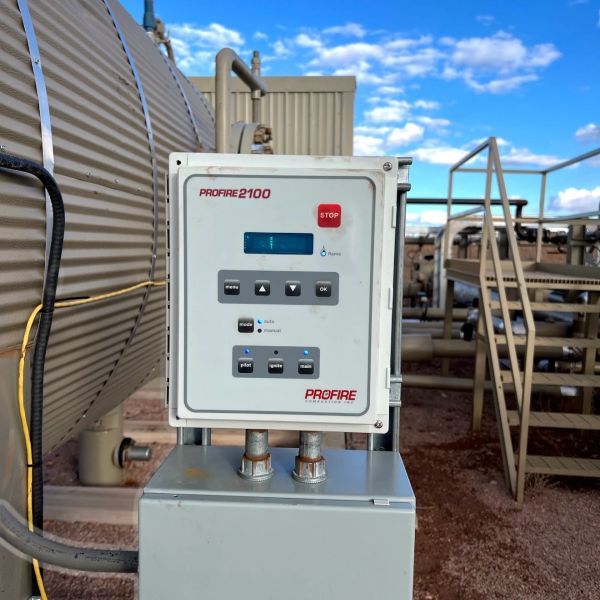 Industrial control panel labeled PROFIRE 2100 with buttons and a display screen outdoors.