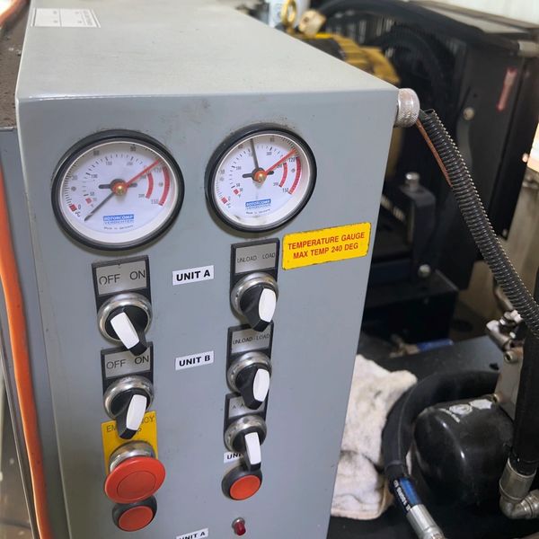 Control panel with pressure gauges and switches labeled Unit A and B.