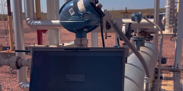 Industrial equipment with a laptop in an outdoor setting.