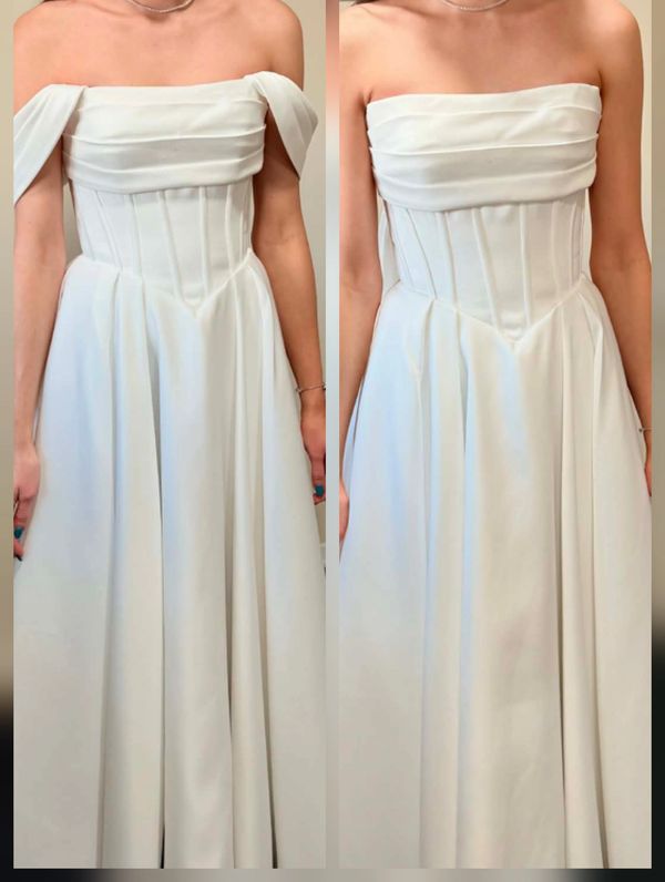 White off-shoulder gown with detachable sleeves, elegant and flowing.